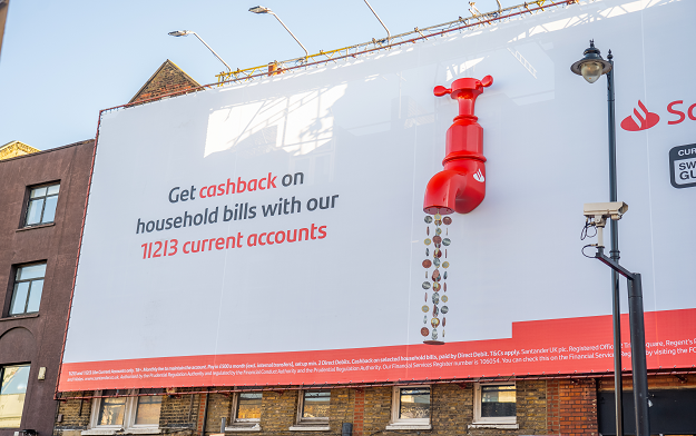 Engine Creative Unveils Massive Billboard Taps Pouring Out Coins For Santander Hackney